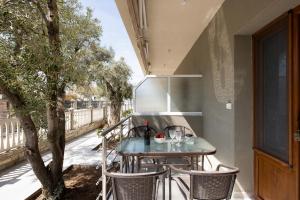 a table on the balcony of a house at Opalium Beach Front Suites in Potos