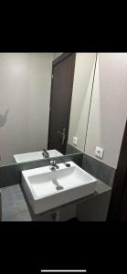 a bathroom with a white sink and a mirror at EL Hotelito in Alija del Infantado