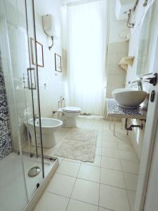 a bathroom with a toilet and a sink and a shower at B&b Il Leccio in Subiaco
