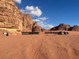 a dirt road in a desert with a mountain at Milk way desert in Wadi Rum