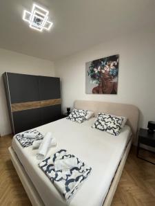 a bedroom with a bed with white sheets and pillows at Guest house with pool Ante in Vrsi