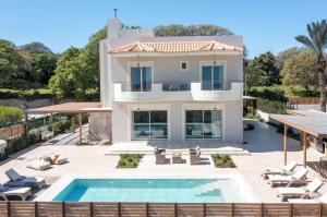 a house with a swimming pool and a villa at Aeon Rhodes - New Villa with private pool in Rhodes Town
