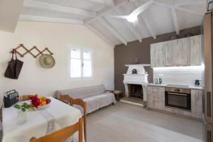 a living room with a table and a fireplace at Eleonas Country House in Marantochori