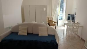 a bedroom with a bed with two pillows on it at Appartamento Saragone in Salerno