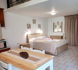 a hotel room with two beds and a table at Anna Studios in Arillas