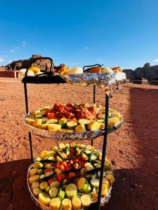 two three tiered plates of fruits and vegetables on display at Milk way desert in Wadi Rum +32 photos