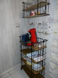 a shelf with plates on it in a room at Villeneuve Loubet Studio 4 p rez de jardin a 5 mn de la mer in Villeneuve-Loubet