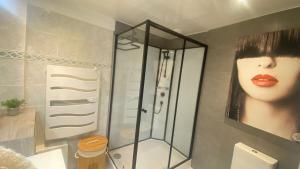 a bathroom with a shower with a picture of a woman at Villeneuve Loubet Studio 4 p rez de jardin a 5 mn de la mer in Villeneuve-Loubet +12 photos