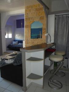 a kitchen with a counter and a living room at Villeneuve Loubet Studio 4 p rez de jardin a 5 mn de la mer in Villeneuve-Loubet