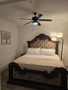 a bedroom with a large bed with a ceiling fan at Comfy Apartment in Frisco in Frisco