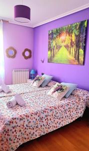 a bedroom with a bed with a painting on the wall at Garnacha Tinta VT-LR-2179 in Haro
