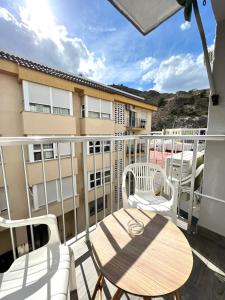 a balcony with a table and chairs and a building at Cullera Sea and Mountain Balcony in Cullera