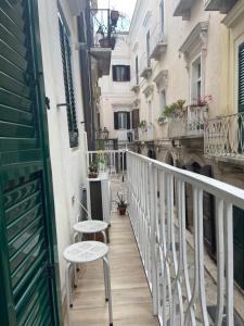 a balcony with two tables and chairs on a building at Casa Fedele in Trani