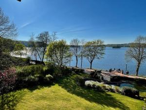 a view of a body of water with trees at Heimathafen Dieksee - mit direktem Seeblick & Balkon am Dieksee in Malente