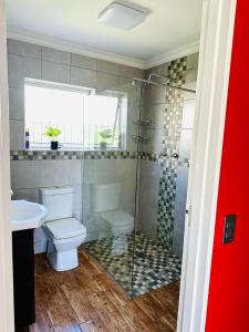 a bathroom with a shower and a toilet and a sink at Casa Da Gama Luxe in Marina Da Gama