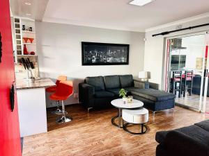 a living room with a couch and a table at Casa Da Gama Luxe in Marina Da Gama