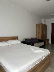 a bedroom with a large bed and a couch at Aqua Batumi 39 in Batumi