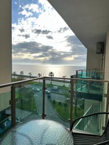a balcony with a view of the ocean at Aqua Batumi 39 in Batumi +4 photos