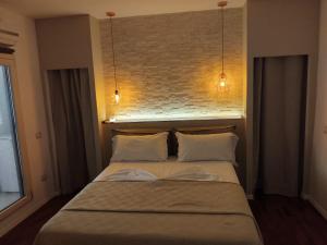 a bed in a bedroom with two lights above it at Lo Zaffiro in Gioia del Colle +24 photos