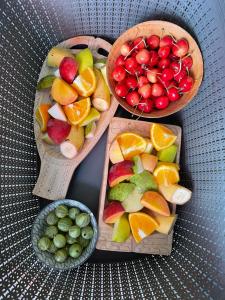 three baskets of fruit and a bowl of cherries and oranges at Fińska Wioska Kalevala in Borowice +28 photos