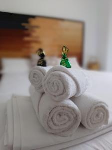 a pile of towels sitting on top of a bed at El Pico de Aroche in Aroche +17 photos