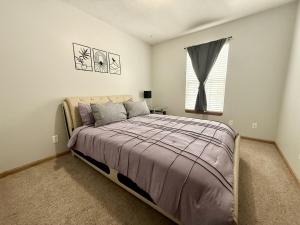 a bedroom with a bed and a window at Centrally Located Family Retreat in Omaha in Omaha