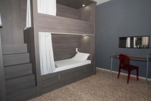 a bed in a room with a desk and a chair at Quart Youth Hostel & Apartments in Valencia