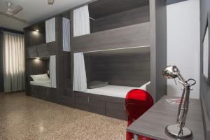 a room with a bunk bed with a desk and a lamp at Quart Youth Hostel & Apartments in Valencia
