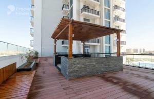an outdoor bar on a balcony of a building at Glamz studio staycation Dubai in Sabkhah