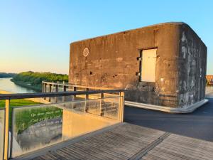 a building on the side of a river at De Smokkelhoeve in Riemst +16 photos
