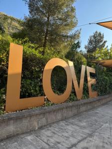 a sign that says love in front of a building at Hotel Sierra de Quesada SL in Quesada