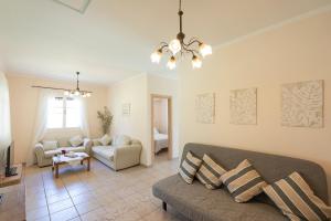 a living room with a couch and a table at Eleonas Country House in Marantochori +71 photos