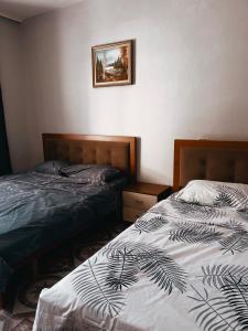 two beds sitting next to each other in a bedroom at El Mare Hotel and Restaurant in Durrës