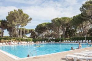 a pool at a resort with people in it at Residence Saint-Raphael Valescure - maeva Home in Saint-Raphaël