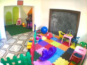 a classroom filled with toys and a chalk board at Pousada Dolce Vita in Itanhaém