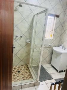 a shower with a glass door in a bathroom at 9 on Deimos Ave in Polokwane