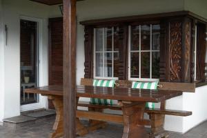 ein Holztisch auf der Veranda eines Hauses in der Unterkunft Chalet Gritli I See I wandern I Luzern I Ski in Beckenried