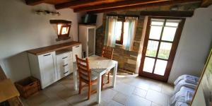 a kitchen with a table and chairs in a room at Studio Apartment Belvedere in Grožnjan