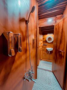 a bathroom with a shower and a sink in a room at Kanav Living - Wooden Cottage in Kanthalloor
