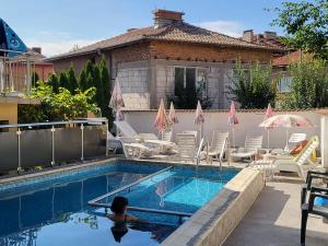 a child is swimming in a swimming pool at Family Hotel Dalia in Velingrad