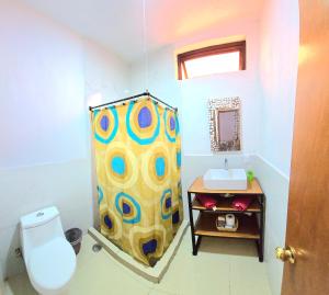 a bathroom with a shower curtain and a sink at Casa Lazcarro1 in Tequila