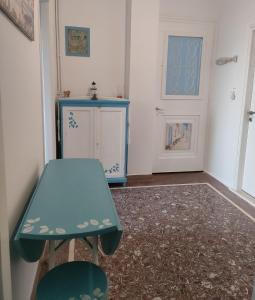 a room with a blue table and a door at Naxos Crafts' House in Naxos Chora +30 photos