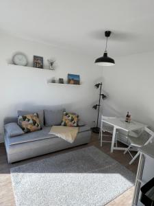 a living room with a couch and a table at Ferienwohnung Alte Brauerei in Leipzig