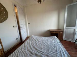 a bedroom with a bed in the corner of a room at Agora House for men only 仅限男性 in Alexandria
