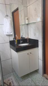 a bathroom with a sink and a mirror at Harmonia em sintonia in Alto Paraíso de Goiás +12 photos