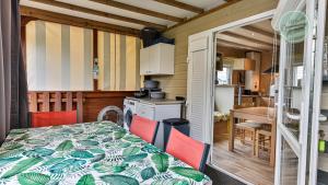 a kitchen and dining room with a table and chairs at Chalet 68 Village de la Mer in Saint-Hilaire-de-Riez