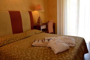 a hotel room with two towels on a bed at AmbientHotels Panoramic in Rimini