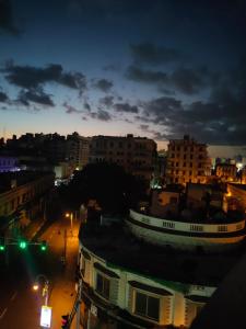 a city at night with buildings and street lights at Agora House for men only 仅限男性 in Alexandria