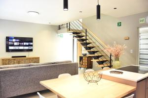 a living room with a couch and a staircase at Rustic Hills #7 Self-catering in Swakopmund