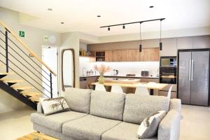 a living room with a couch and a kitchen at Rustic Hills #7 Self-catering in Swakopmund